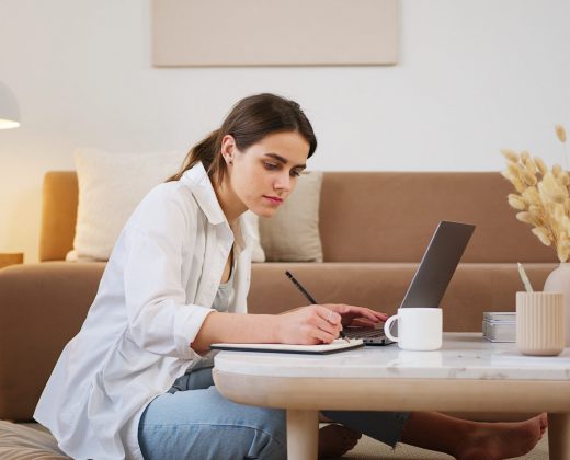 young-woman-using-laptop-and-taking-notes-4492126